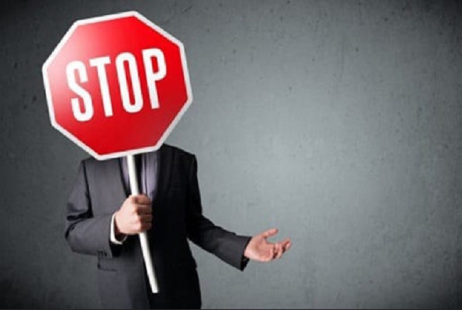 man holding stop sign